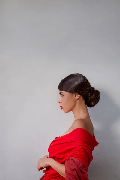 Jovem atraente em vestido vermelho no fundo — Fotografia de Stock