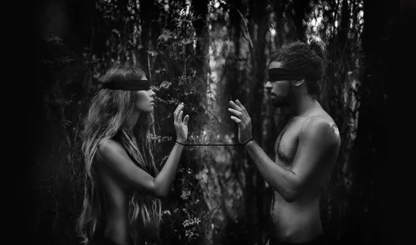 Atrractive young man and woman with eyes closed. lost in forest — Stock Photo, Image