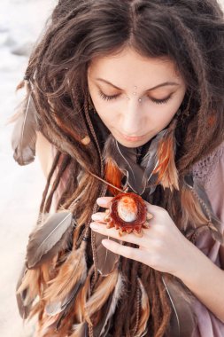 portrait of young tender bohemian style woman relaxing on beach