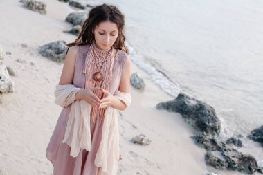 portrait of young tender bohemian style woman relaxing on beach