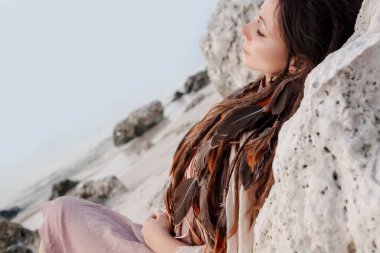 portrait of young tender bohemian style woman relaxing on beach