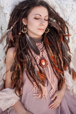 portrait of young tender bohemian style woman relaxing on beach