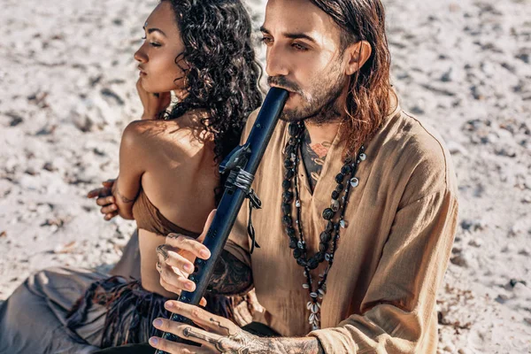 Belo jovem casal tocando música étnica com tambores xamã — Fotografia de Stock