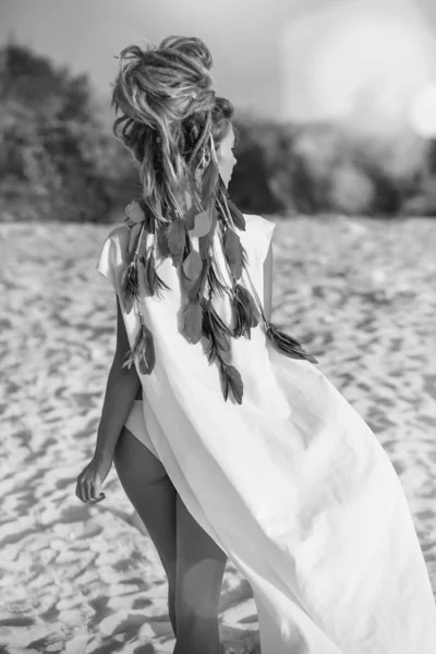 attractive bohemian style woman posing at the beach