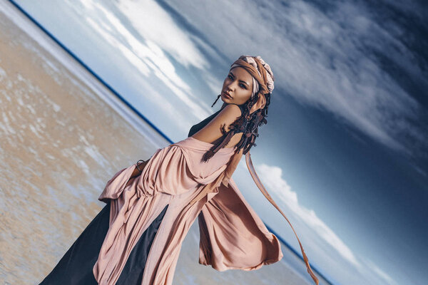 beautiful stylish bohemian woman posing at tropical beach, gypsy concept