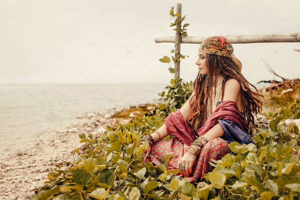 attractive gypsy style young woman posing outdoors