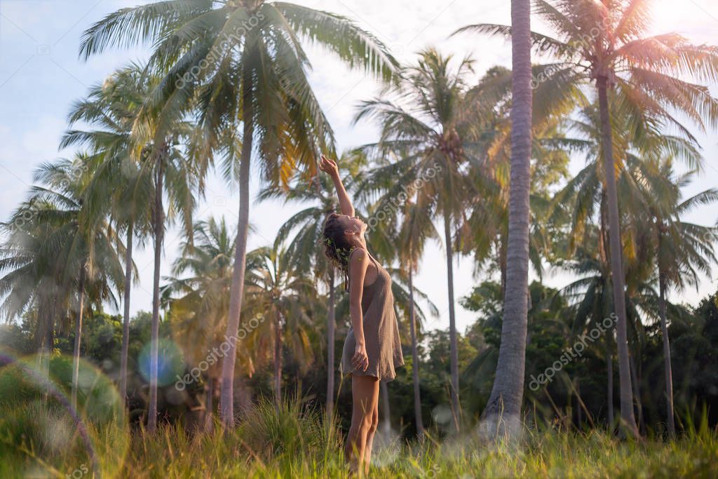 attractive young woman posing on tropical background