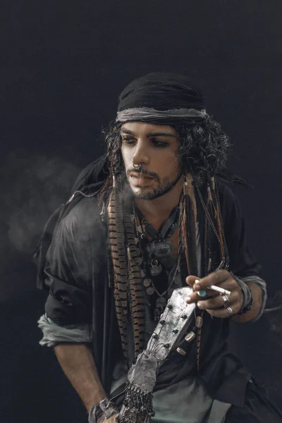 conceptual pirate boho man posing to camera