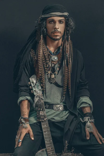 conceptual pirate boho man posing to camera