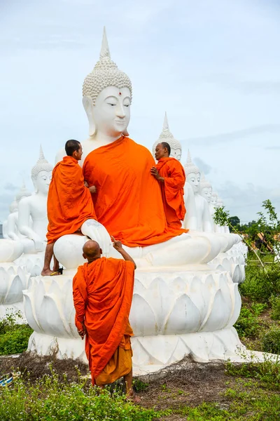 Monks dressing one of White Buddha Image with robes — Stock Photo, Image