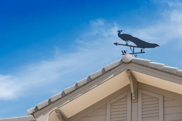 Weather vane with peacock.