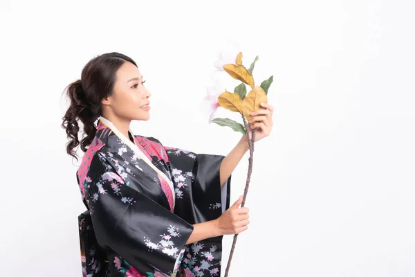 Beautiful attractive asian woman wearing traditional japanese kimono with a bouquet of beautiful flowers isolated on white background