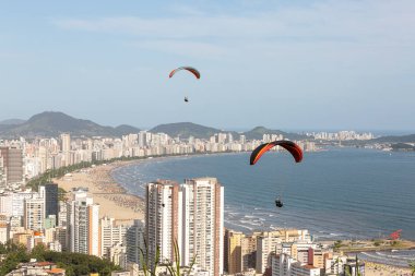 Paragliders flying over the city of Santos and Sao Vicente, Braz