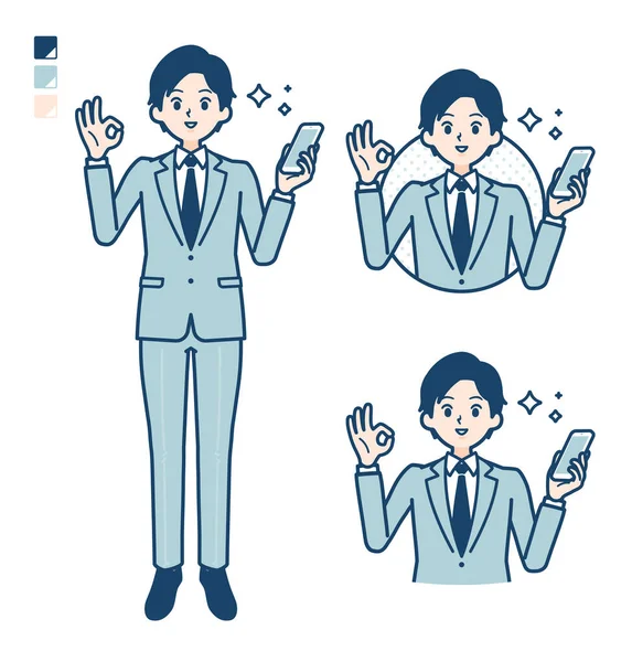 Takım elbiseli genç bir iş adamı elinde akıllı bir telefonla 