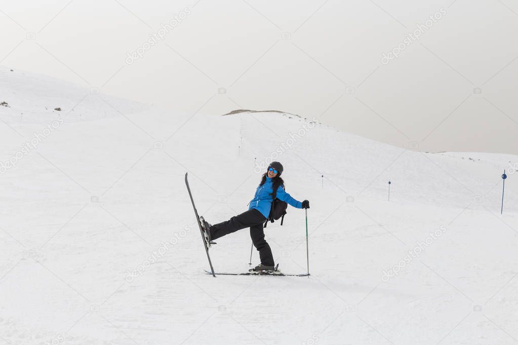 Skier woman on top of the mountain. Winter season