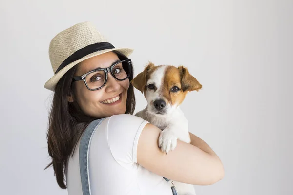 Wanita muda yang cantik bermain dengan anjing kecilnya yang lucu di rumah . — Stok Foto