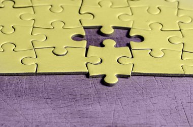 white jigsaw/puzzle with one piece at wrong position, over  black wooden table background, symbol of problem solving and new vision clipart