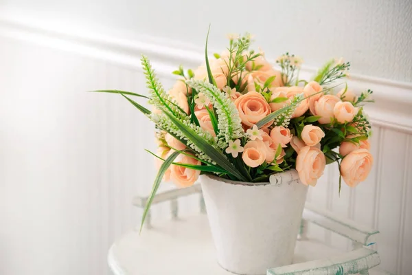 Pink spring flowers in a pot in a light interior.