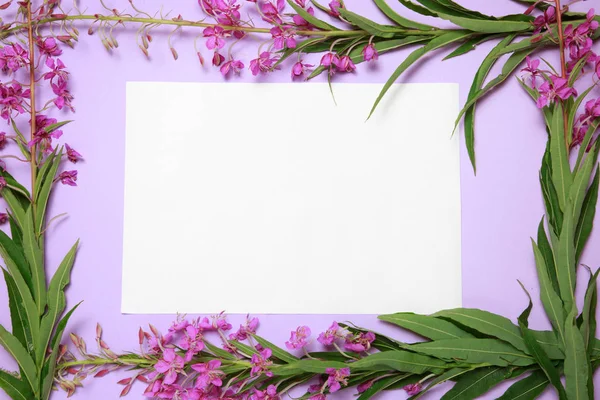 A floral frame of willow-tea in a circle of white paper lies on a lilac background.