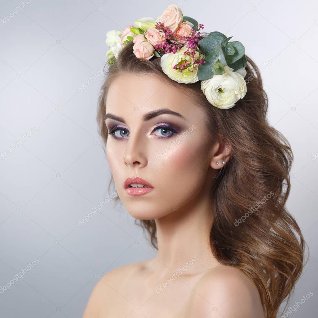 Delicate portrait of young woman with wreath on head