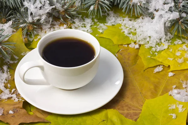 Coffee in a white mug and snow — Stock Photo, Image