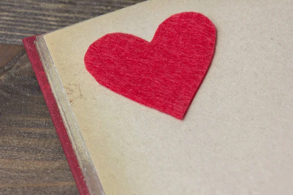 Red felt heart on the book — Stock Photo, Image