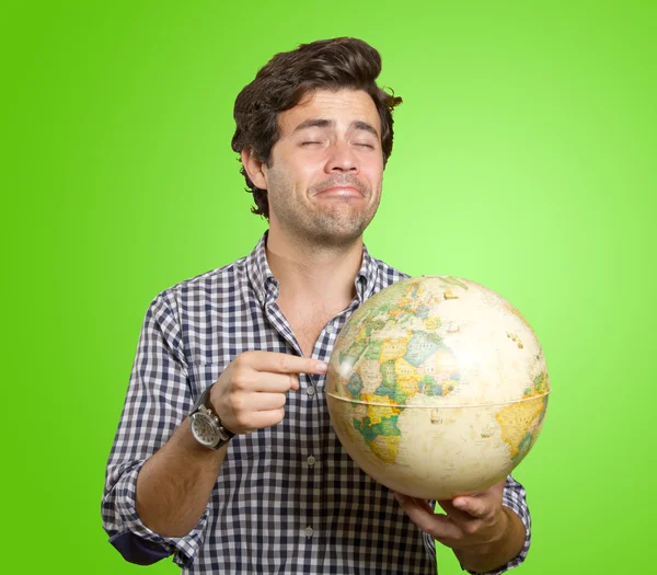 Man with world globe for trip — ストック写真