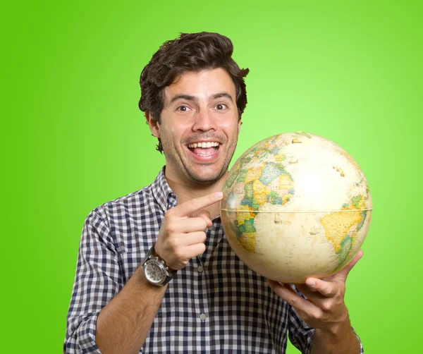 Man with world globe for trip — ストック写真