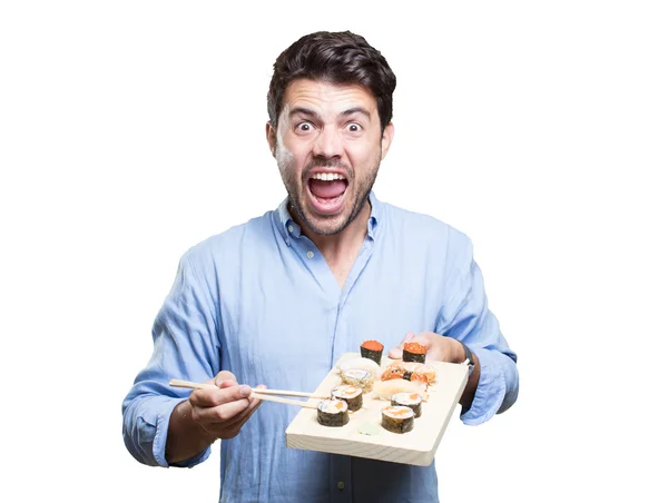 Jovem comendo sushi no fundo branco — Fotografia de Stock