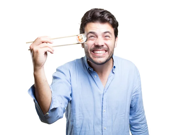 Joven comiendo sushi sobre fondo blanco — Foto de Stock