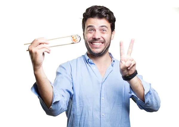 Joven comiendo sushi sobre fondo blanco — Foto de Stock