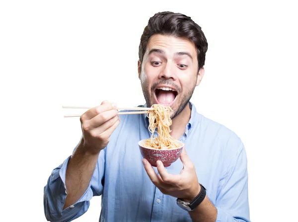 Jovem comendo sushi no fundo branco — Fotografia de Stock