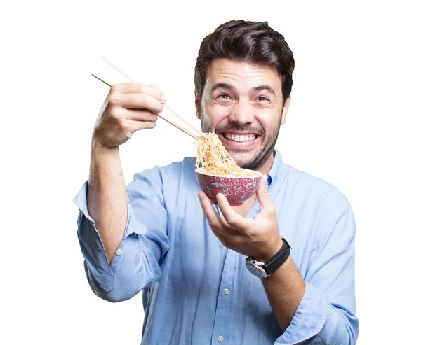 Jovem comendo sushi no fundo branco — Fotografia de Stock