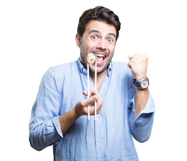 Молода людина їсть суші на білому тлі — стокове фото