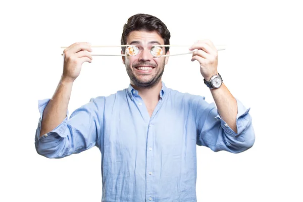 Joven comiendo sushi sobre fondo blanco — Foto de Stock