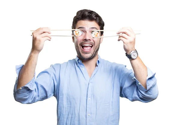 Joven comiendo sushi sobre fondo blanco — Foto de Stock