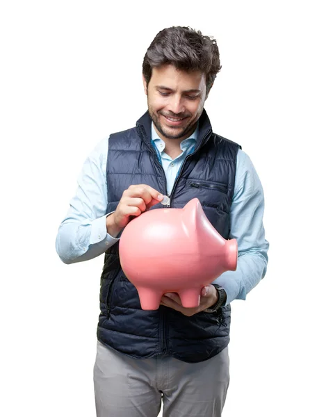 Mann mit Weste setzt Münze auf Schwein — Stockfoto