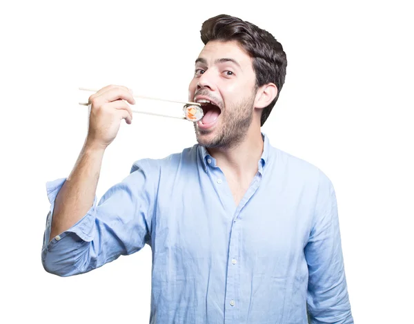 Young man eating sushi on white background Stock Picture