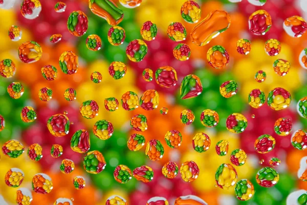 Colorful candies in drops of water — Stock Photo, Image