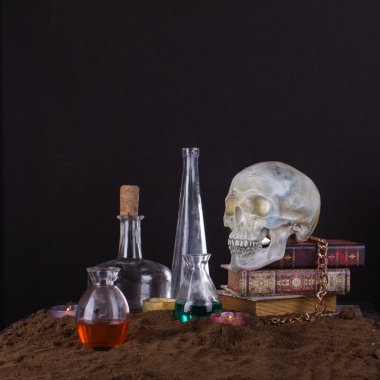 Halloween still life with skull, books, candles and bottles of p clipart