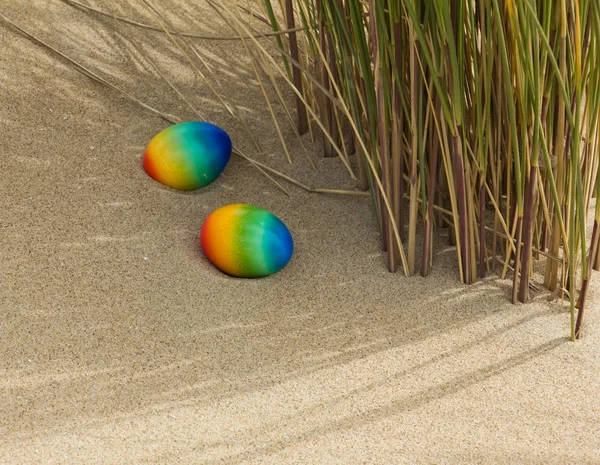 Easter concept, two colored eggs on the beach . — Stock Photo, Image