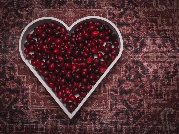 Red  berries in a heart shape representing love and valentines d