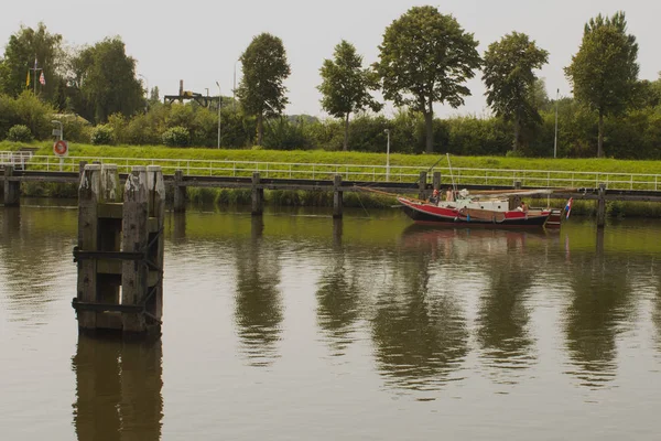 Particular boat on Holland canal in front of dutch style — Stock Photo, Image
