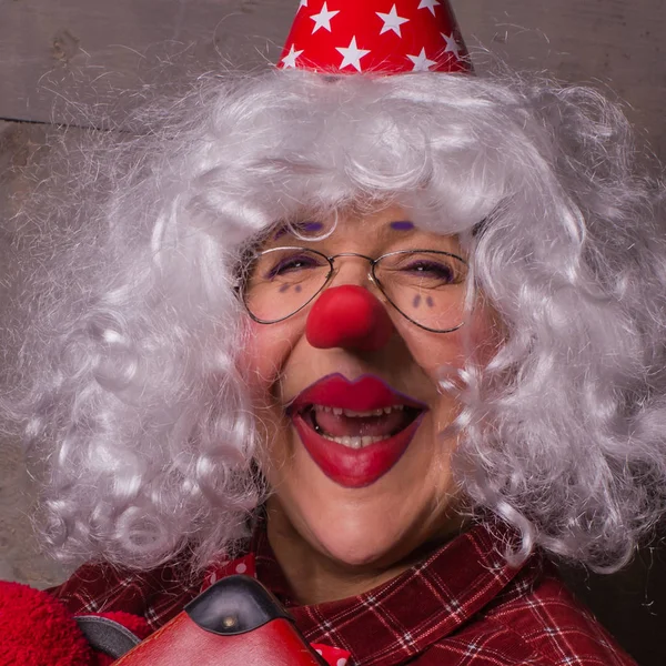 Cheerful clown with blonde wig