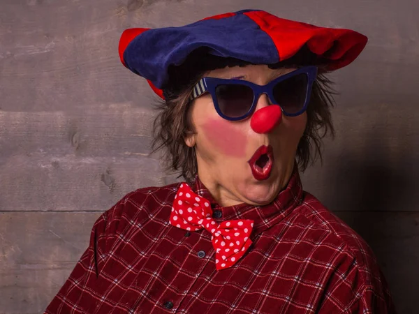 Αστείο κλόουν γυναίκα με την κόκκινη μύτη και τα μπλε γυαλιά ηλίου. Κωμωδία conc — Φωτογραφία Αρχείου