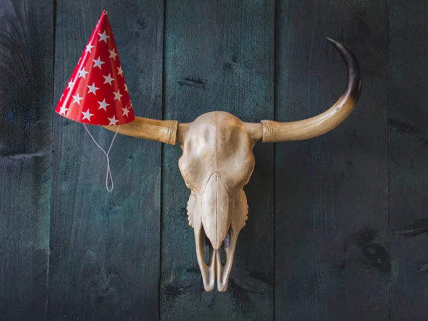 Party and celebration. Buffalo skull with paper red funny party