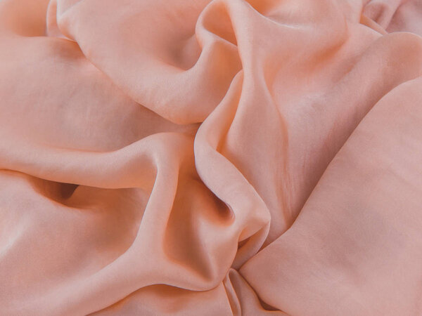 Абстрактный фон. Пастельно-бежевая шелковая ткань, мягкие складки
. 