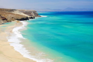 Beach with amazing water colors on Fuerteventura, Spain. clipart