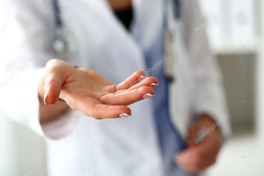 Female medicine doctor offering helping hand closeup — Stock Photo