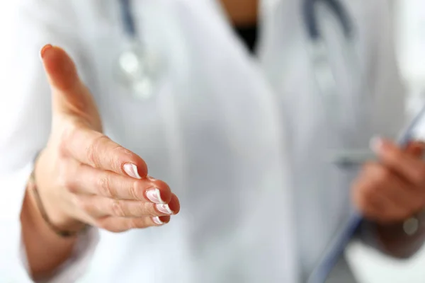 Female medicine doctor offering hand to shake in office closeup — Stock Photo, Image